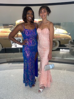 Two attendees posing in evening gowns